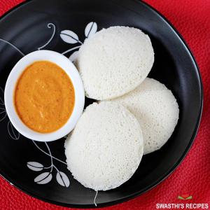 a plate of food with a bowl of dipping sauce at Hotel Emerald Near T2 International Airport Mumbai in Mumbai