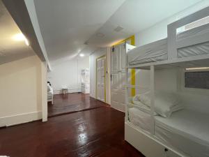 a room with two bunk beds and a hallway at Owls Hostel Ildefonso in Porto