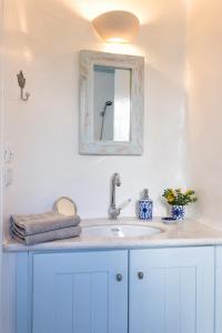 a bathroom with a sink and a mirror at Azure Villa Paros in Drios +17 photos