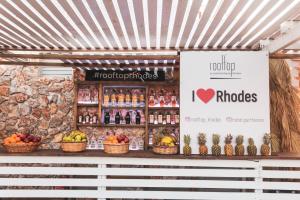 a fruit stand with fruits and drinks on display at Hotel Parthenon Rodos city in Rhodes Town