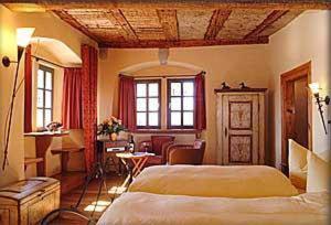 a hotel room with a bed and a table and chairs at Klosterstüble in Rothenburg ob der Tauber