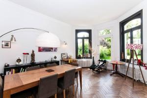 een woonkamer met een houten tafel en stoelen bij Very nice old house closed to Lille in Mouvaux