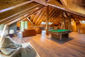 a living room with a pool table in a cabin at Casa Maristany in Camprodon