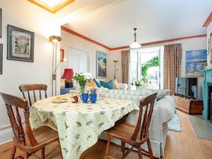uma sala de estar com uma mesa e um sofá em Port View Cottage em Shaldon