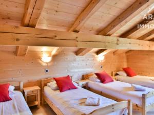 a room with three beds in a log cabin at Chalet Le Grand-Bornand, 10 pièces, 18 personnes - FR-1-391-29 in Le Grand-Bornand