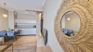 a living room with a large mirror on the wall at HOLIDAY HOME Bel Mare 514e in Międzyzdroje