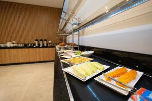 a buffet line with many different types of food at Safa Hotel Foz in Foz do Iguaçu