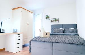 NeirivueにあるGruyère Alpes Appartement 3 chambres BBQ Parkingのベッドルーム1室(ベッド1台、ノートパソコン付きのデスク付)