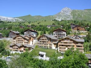 a group of apartment buildings in a mountain at Appartement Le Grand-Bornand, 2 pièces, 4 personnes - FR-1-391-95 in Le Grand-Bornand