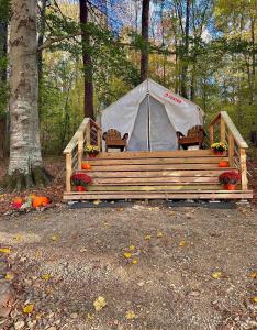 a tent with chairs and flowers in front of it at Tentrr Signature Site - Huff Farm in Maryville