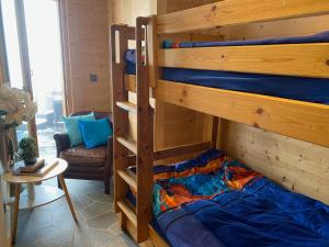 a bedroom with two bunk beds in a room at B&B rooms within a modern family chalet with direct access to ski area in Verbier in Verbier