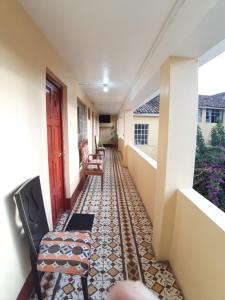 a hallway of a house with chairs and a floor at HOSPEDAJE CENTRAL in Ayacucho