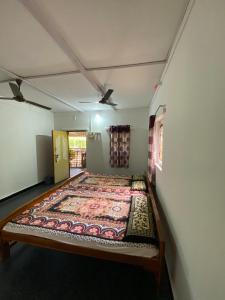 a bed in a room with a rug on the floor at Aviraj Nivas in Dapoli