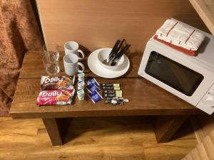 a table with a microwave and snacks on it at Barn 6 in Vigo Village