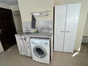 a kitchen with a washing machine and a sink at Studio 5 in Varna City