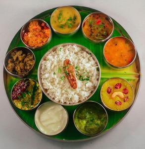 a plate of food with rice and different types of food at Chalobahills Farmstay Resort in Ajra