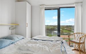 - une chambre avec un lit, une chaise et une fenêtre dans l'établissement Beautiful Apartment In Fan With Kitchen, à Fanø