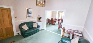 a living room with a couch and a chair at mySTAYINN Abermar Guest House in Inverness