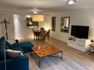 a living room with a blue couch and a table at L'atelier du gîte bleu in Willgottheim