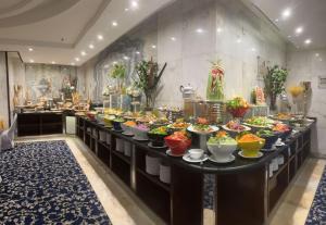 a buffet line with bowls of food on display at Maysan Al Mashaer Hotel in Mecca