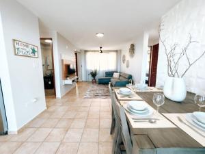 a living room with a dining table and a living room at Oasis Village Spacious Apt W/ Ocean View For 9 in Rio Grande