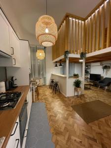 a kitchen and living room with wooden floors at Bocskai Apartman in Szeged