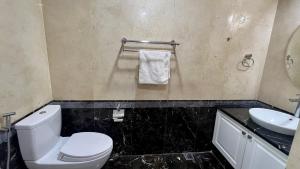 a bathroom with a white toilet and a sink at Thanh Ha Hotel in Chơ Mơi