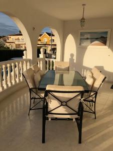 a glass table and chairs on a patio at Casa Sara - Private Villa with Private Pool in Ciudad Quesada