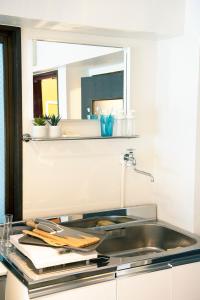 a kitchen counter with a sink and a mirror at #2 3stops to Shinjuku station stylish spacious studio apartment in Tokyo