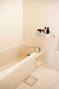 a bathroom with a bath tub with a sink at #2 3stops to Shinjuku station stylish spacious studio apartment in Tokyo