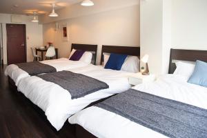 two large beds sitting next to each other in a room at #2 3stops to Shinjuku station stylish spacious studio apartment in Tokyo