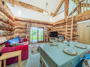 a living room with a table and a couch at Hollacombe Lodge in Colebrooke