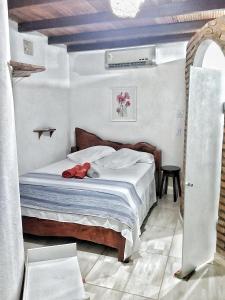 a bedroom with a bed with a red shoes on it at Pousada Maravilha Itacaré in Itacaré