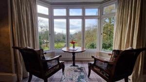 een kamer met 2 stoelen en een tafel voor een raam bij Ambleside Manor - Vegetarian B&B in Ambleside