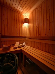a wooden bench in a sauna with a light at Zigen House in Bansko