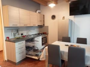 a kitchen with a sink and a dishwasher at Casa Weber Levico Terme in Levico Terme