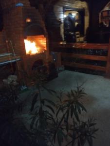 Un horno de ladrillo con fuego. en Cabana familiei, 