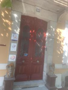 a large wooden door in a building with two heads at GUESTHOUSE La VILLAE in Mazamet