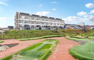 a building with a golf course in front of it at 1 Bedroom Stunning Apartment In Fan in Fanø