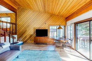 a living room with a table and a tv at Huntington Lake Condo #38 in Lakeshore