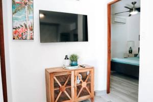 a room with a mirror on a wall with a table at Casona Apt 3 @ Ocean Park / 3 min Walk to Beach - Nuevo in San Juan