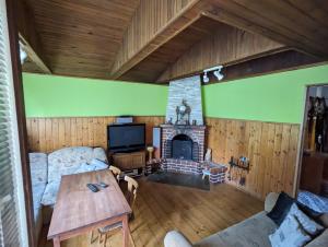 a living room with a couch and a fireplace at Różany Domek in Wojnówko +22 photos