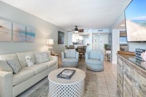 a living room with a couch and chairs at Perdido Sun Resort 1108 by PKRM in Pensacola