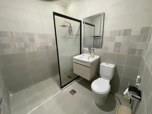 a bathroom with a toilet and a sink and a shower at Oskar Appartment in Wadi Musa +18 photos