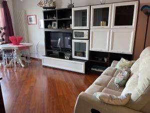 a living room with a couch and a tv at Mareincasa Dimora Luxury in Polignano a Mare