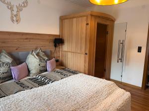 Un dormitorio con una cama con almohadas. en Ferienwohnungen am Riedanger, en Mayrhofen