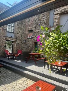 a patio with tables and chairs and a building at Kings Arms Hotel in Ulverston