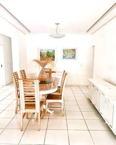 a dining room with a table and chairs at house with swimmingpool, sauna and games room. in Angra dos Reis