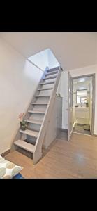 a white staircase in a room with a kitchen at SUPERBE 2P MEZZANINE AU COEUR DU VIEIL ANTIBES in Antibes