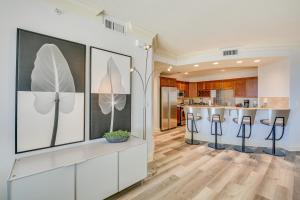 a kitchen with a bar with stools at Emerald Grande Condo Beach, Marina and Ocean View in Destin